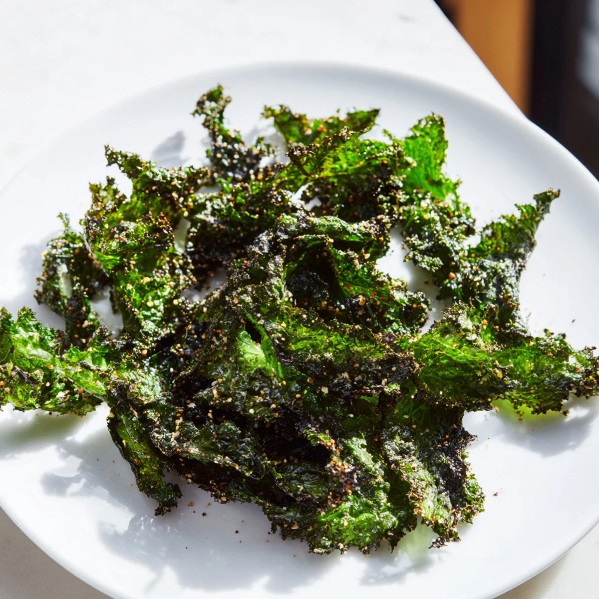 Golden, crispy baked kale chips, a healthy homemade snack with a satisfying crunch and sea salt.