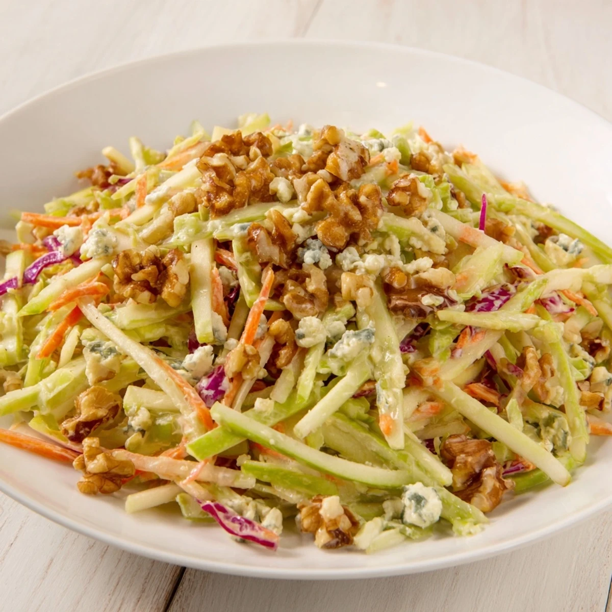 A close-up of the finished Apple & Walnut Slaw, showcasing crisp apple slices and toasted walnuts.