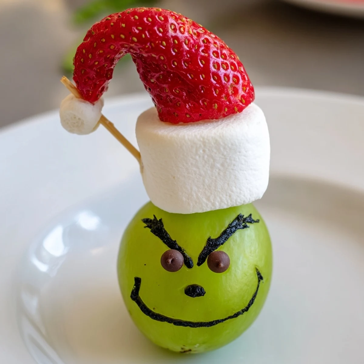 Adorable Grinch Snack with marshmallow "faces" and juicy green grapes ready to eat in minutes.