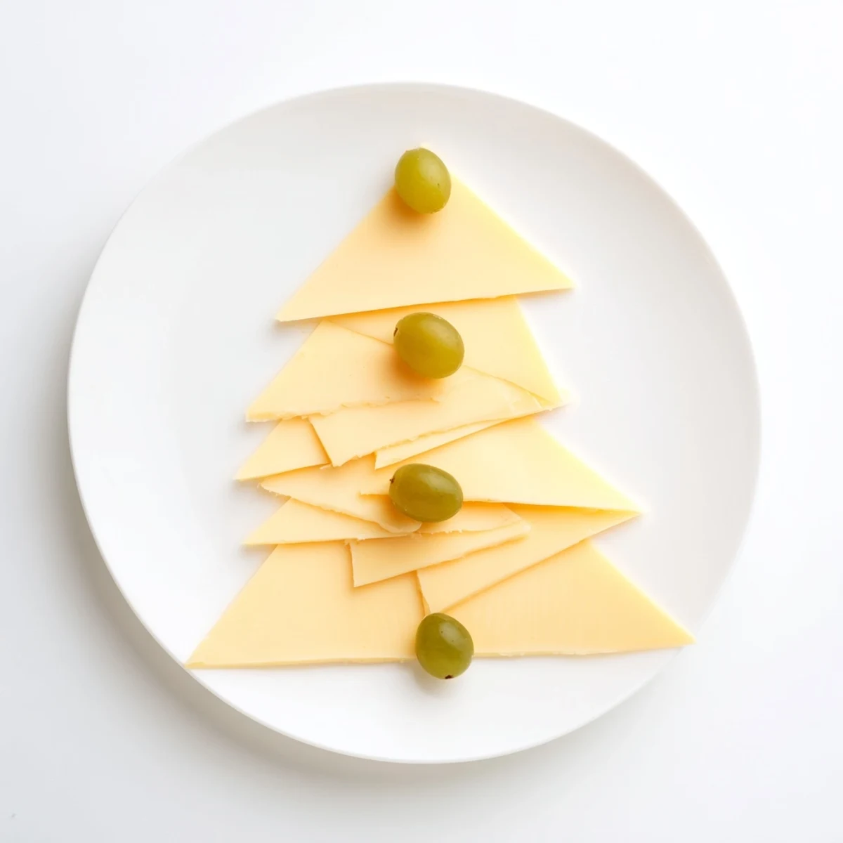 The Tannenbaum Border: A festive cheese board framed with cheese trees and green grapes, ready to serve.