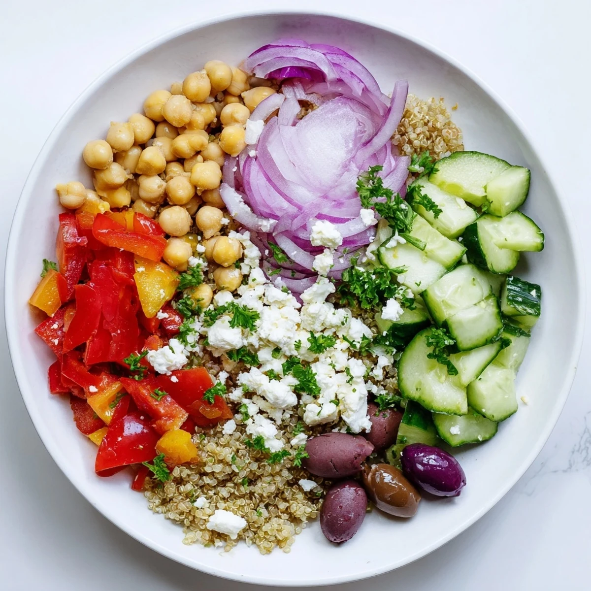 Fresh, vibrant Mediterranean Chickpea and Feta Bowl, topped with crumbled feta cheese and Kalamata olives.