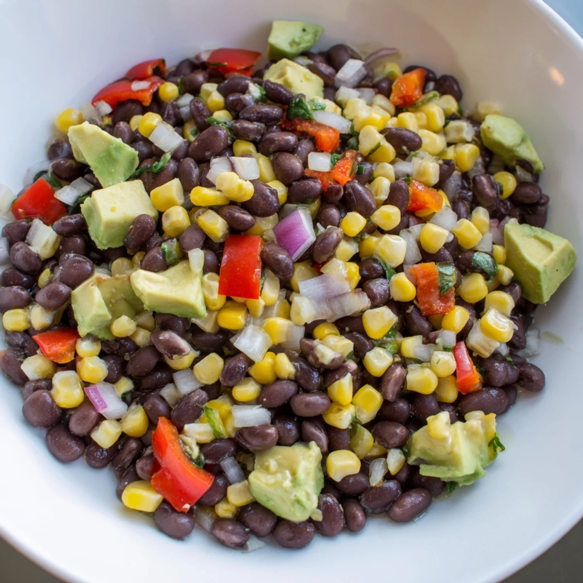 Enjoy a refreshing bowl of Southwestern Black Bean and Corn Salad, perfect for summer.