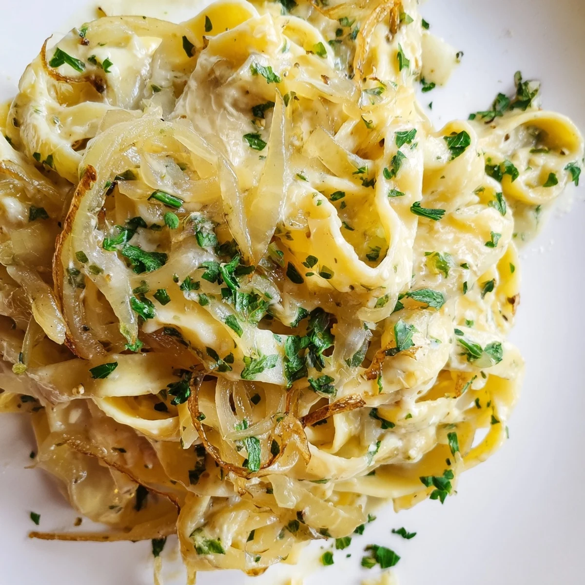 Golden, caramelized onions topping steaming One-Pot French Onion Pasta, ready for a comforting bite.