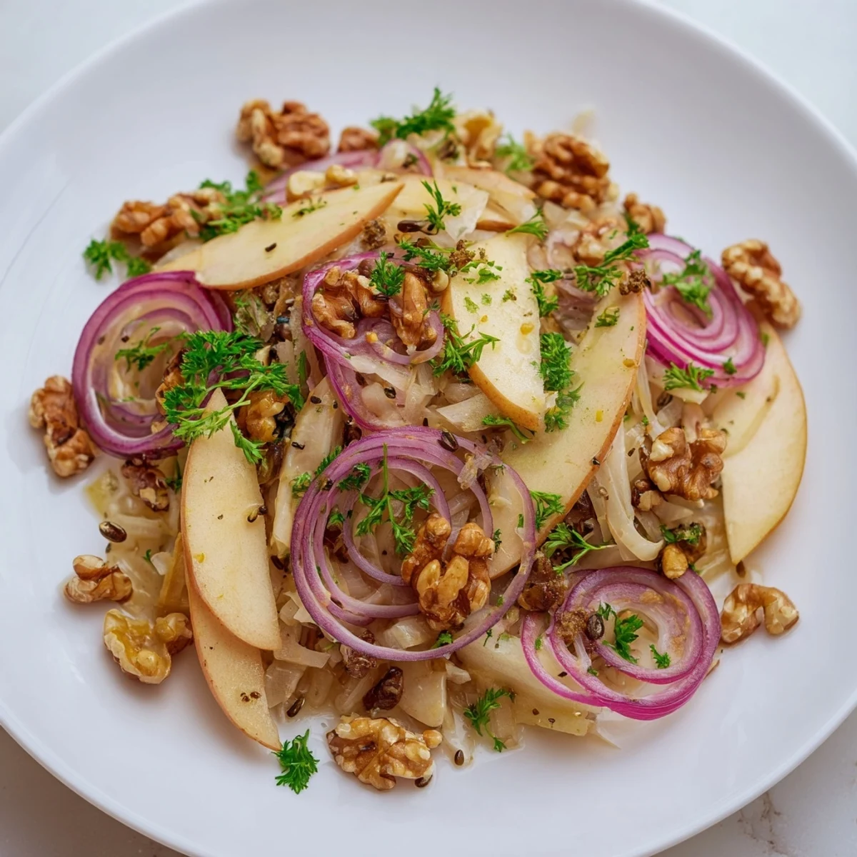 Serving suggestion for a tangy Apple and Sauerkraut Skillet Salad, plated warm with a drizzle of apple cider vinegar.