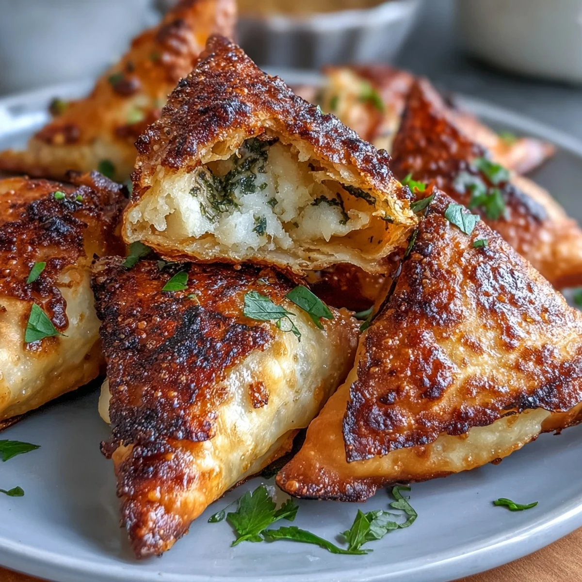 Flaky samosas stuffed with spiced vegetables, air-fried until crisp, and served with zesty mint chutney on the side.