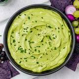 Creamy green Witch's Brew Cauldron dip served in a black bowl, perfect for a spooky Halloween gathering.
