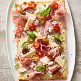 Shareable The Rustic Raft flatbreads loaded with salami, prosciutto, and creamy cheeses for an easy appetizer.