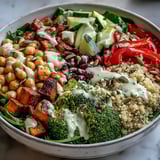 Colorful Meal Prep Week-Long Power Bowl featuring quinoa, roasted broccoli, chickpeas, and crunchy almond topping.