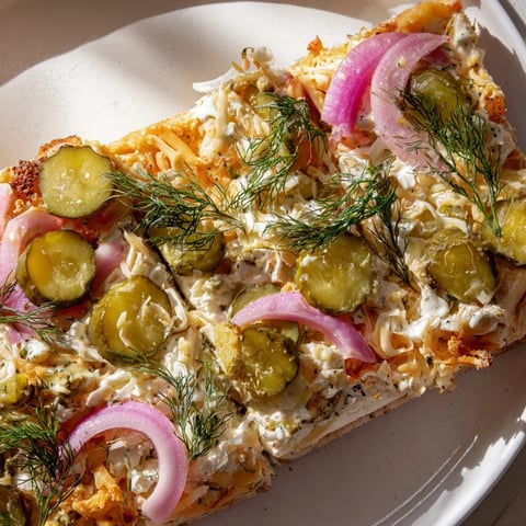 Creamy Pickle Pizza topped with mozzarella and crunchy dill pickles slices.  