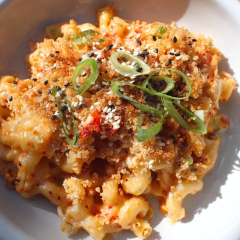 Creamy Spicy Kimchi Mac & Cheese topped with crunchy sesame for added texture.