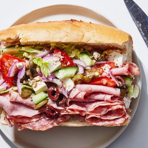A mouthwatering Flavor Mash-Up Sandwich, overflowing with fresh Italian ingredients and colorful toppings.  