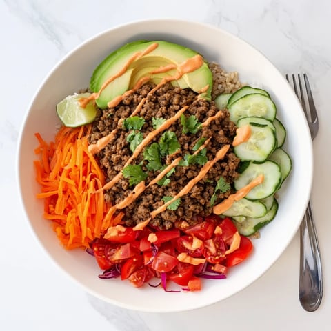 Colorful Plant-Based Meat Bowl garnished with fresh vegetables and lime slices.  