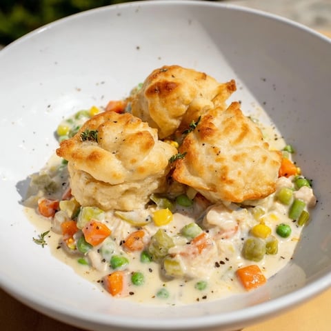 Golden-brown Chicken and Dumplings Casserole baked to bubbly perfection, a comforting family meal.