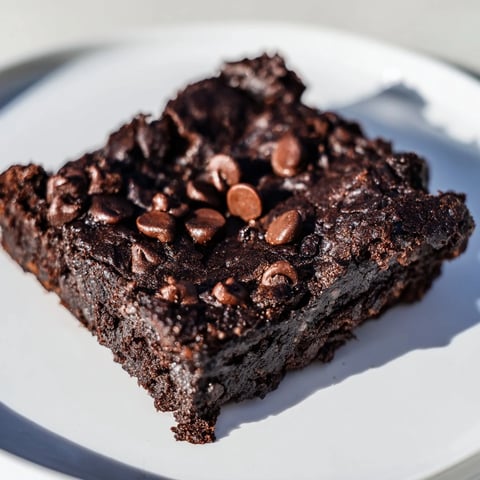 Moist, fudgy Black Bean Brownies with chocolate chips, ready to slice and enjoy as a treat.