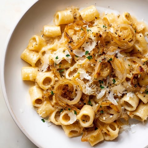 Golden, bubbling Creamy French Onion Ditalini, a warm pasta dish topped with melted Gruyère cheese.