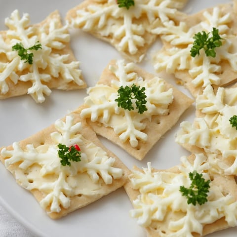 Savory Bites: Cracker and Cheese Snowflake Design, a beautiful, festive appetizer with cheese snowflakes, ready to eat!