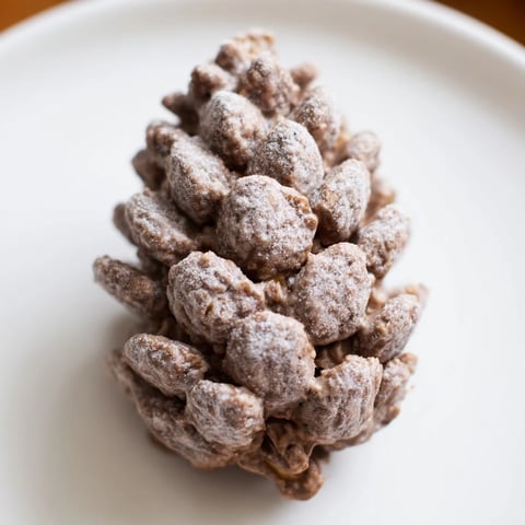 Pinecone-shaped nut butter snacks ready to be enjoyed, a delightful, festive treat with crunchy cereal.