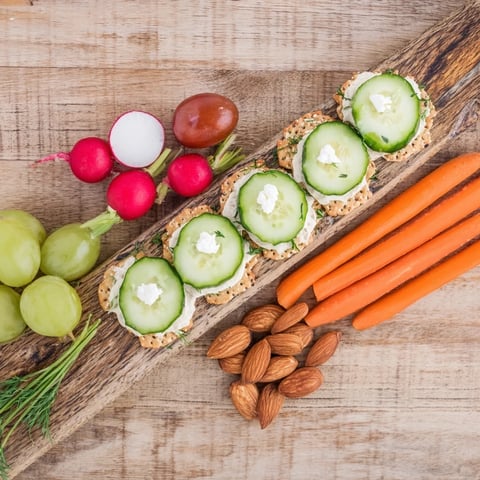 Symmetrical Zen Balance appetizer board with vibrant vegetables, goat cheese, and almonds, ready to enjoy.