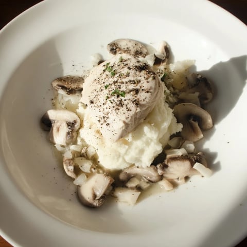 A plated Ghostly Gala shows tender poached chicken and creamy cauliflower, ready to eat.