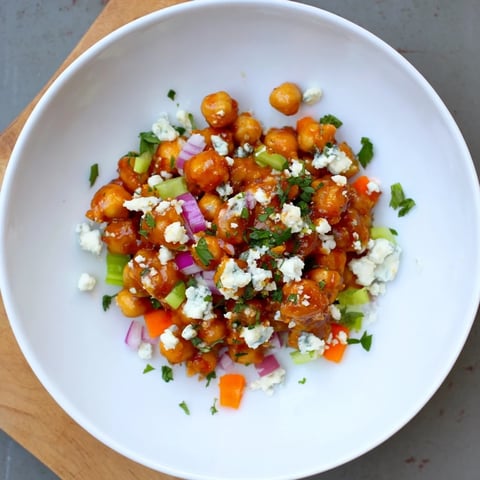 Vibrant Buffalo Chicken Bean Salad, picturing juicy chickpeas coated in fiery buffalo sauce, garnished with blue cheese.