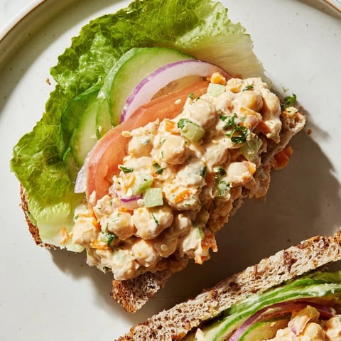 Image Of A Filling Easy Chickpea Salad Sandwich with visible fresh, colorful vegetables and creamy filling.
