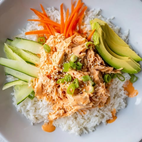 A colorful Spicy Canned Salmon Rice Bowl ready to eat, featuring fresh veggies and creamy salmon.