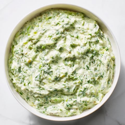 Creamy, flavorful Green Goddess Dip served with colorful crunchy vegetables, a perfect appetizer.