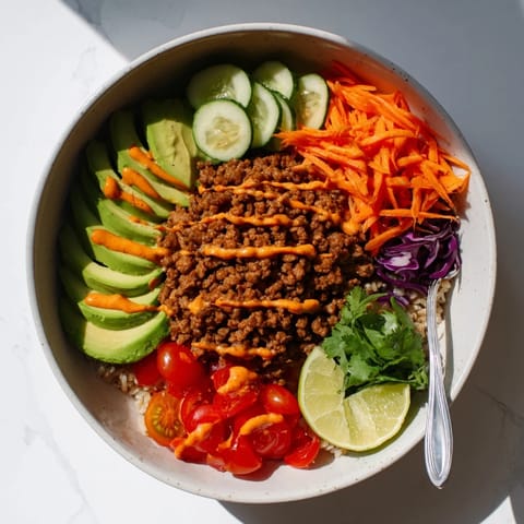 Hearty Plant-Based Meat Bowl bursting with spices, served over quinoa and veggies.  