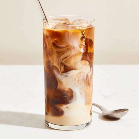 Creamy and nutty tahini iced coffee drizzled with maple syrup delight.  