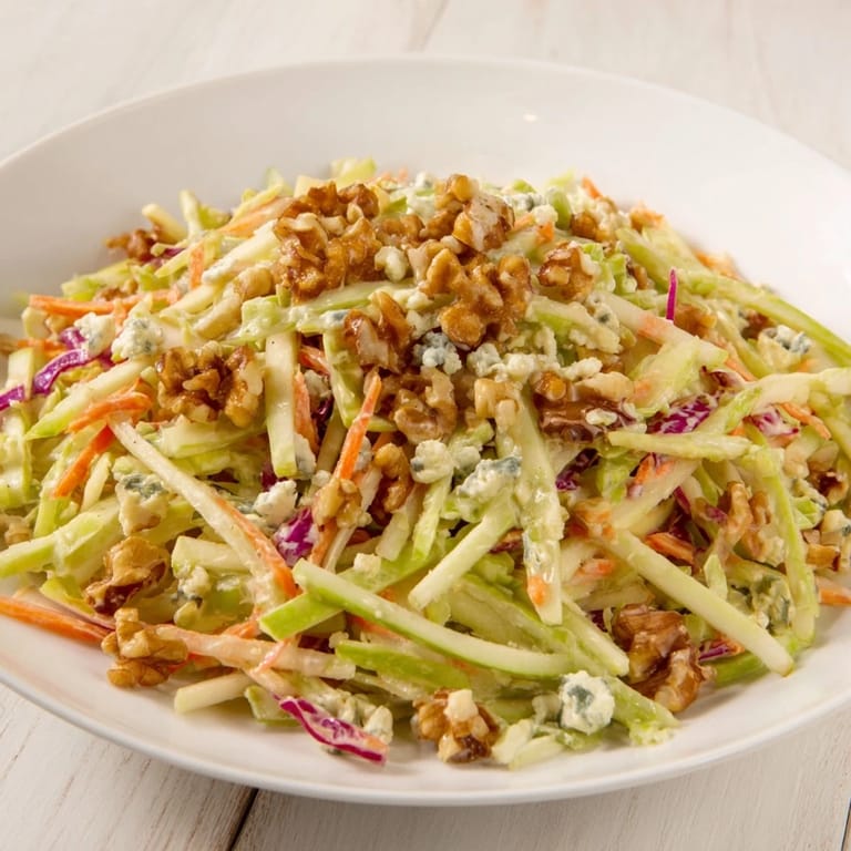 A close-up of the finished Apple & Walnut Slaw, showcasing crisp apple slices and toasted walnuts.