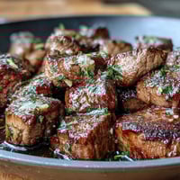One-pan garlic herb steak bites with juicy seared sirloin and fresh parsley, perfect for a quick summer dinner.